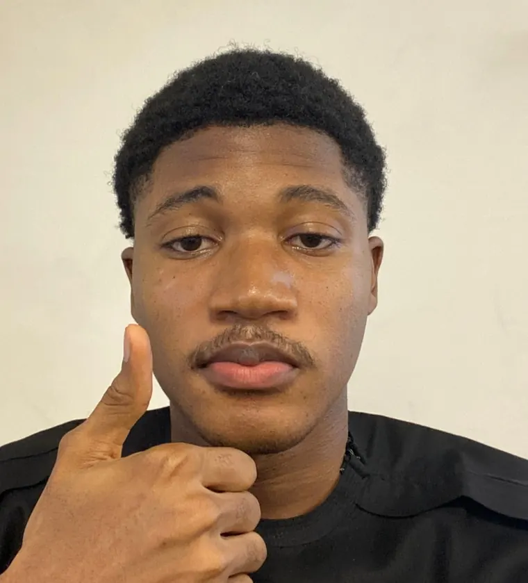 Howard in a black T-shirt, giving a thumbs up